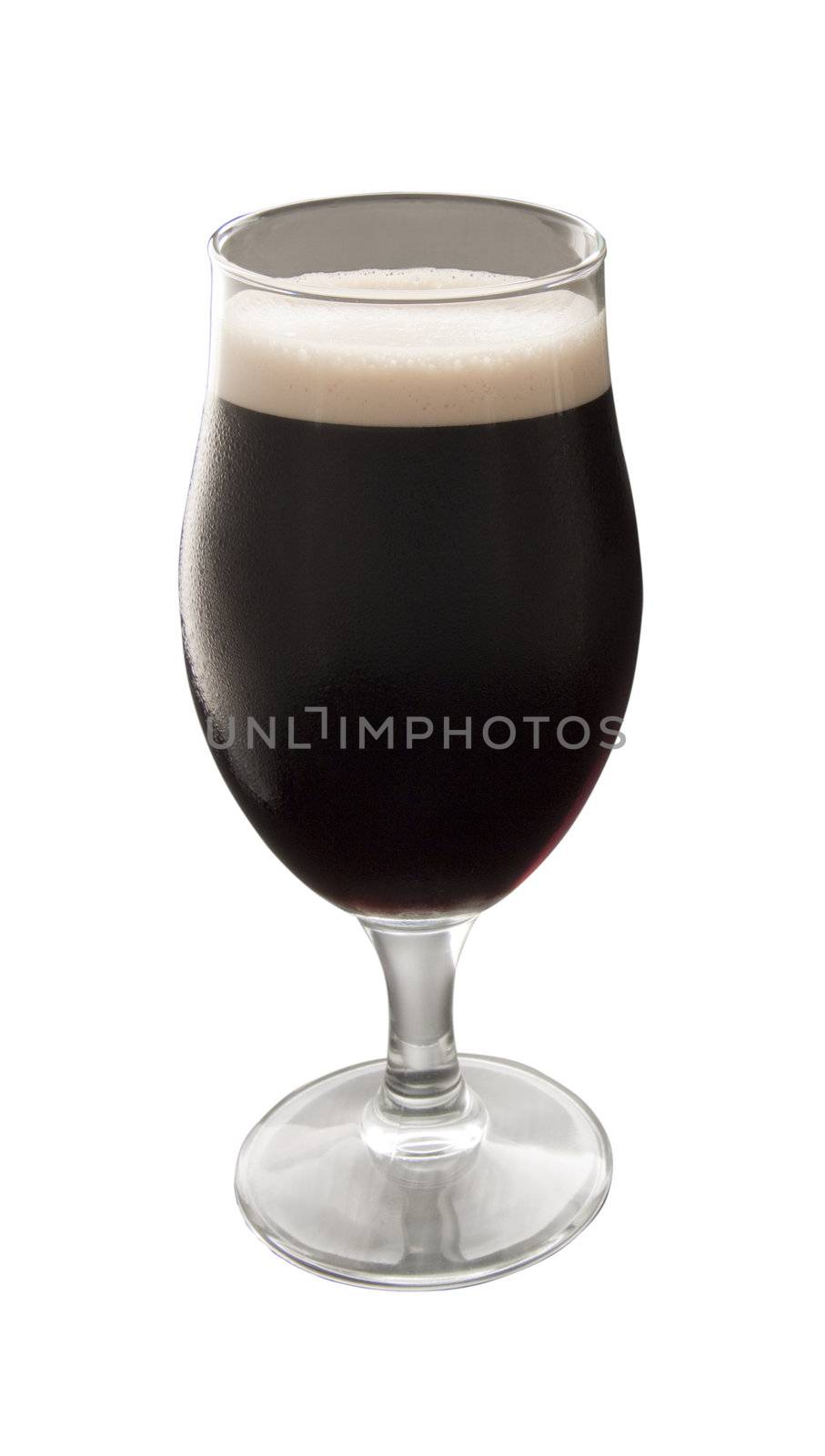 Close up of a glass of irish stout over white background