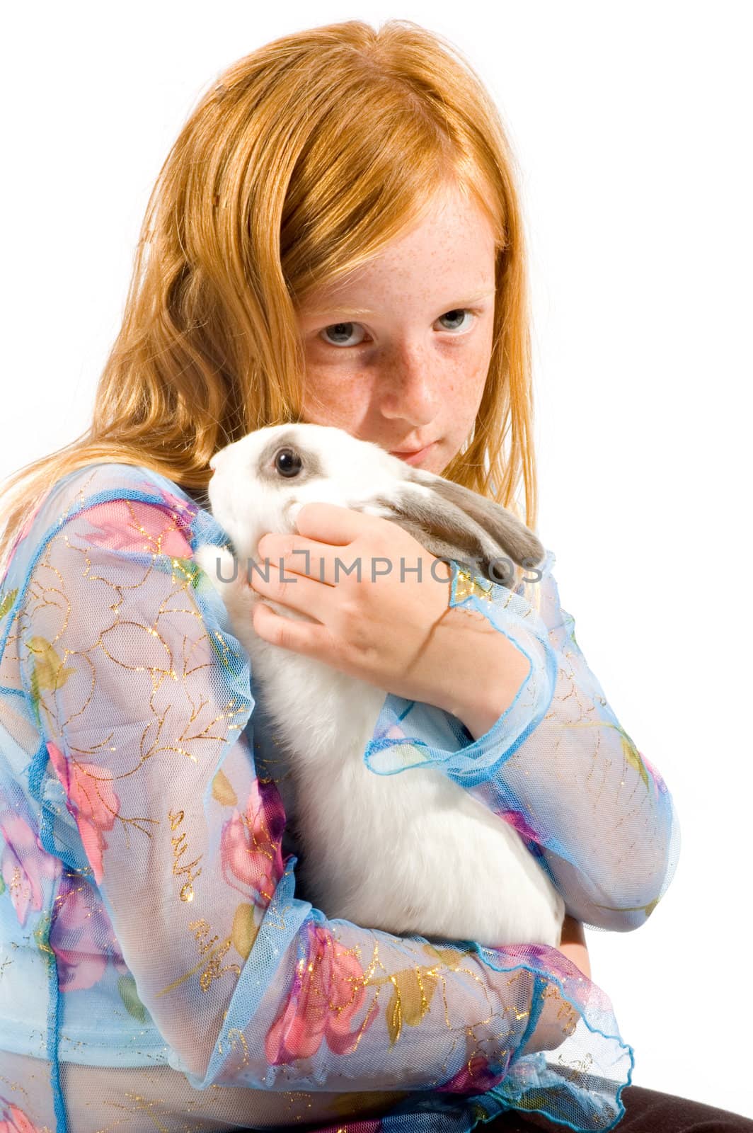 redhead girl is cuddling with a white rabbit isolated