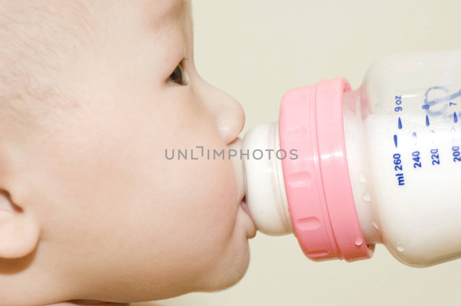 6 months old Asian baby boy drinking bottle milk 
