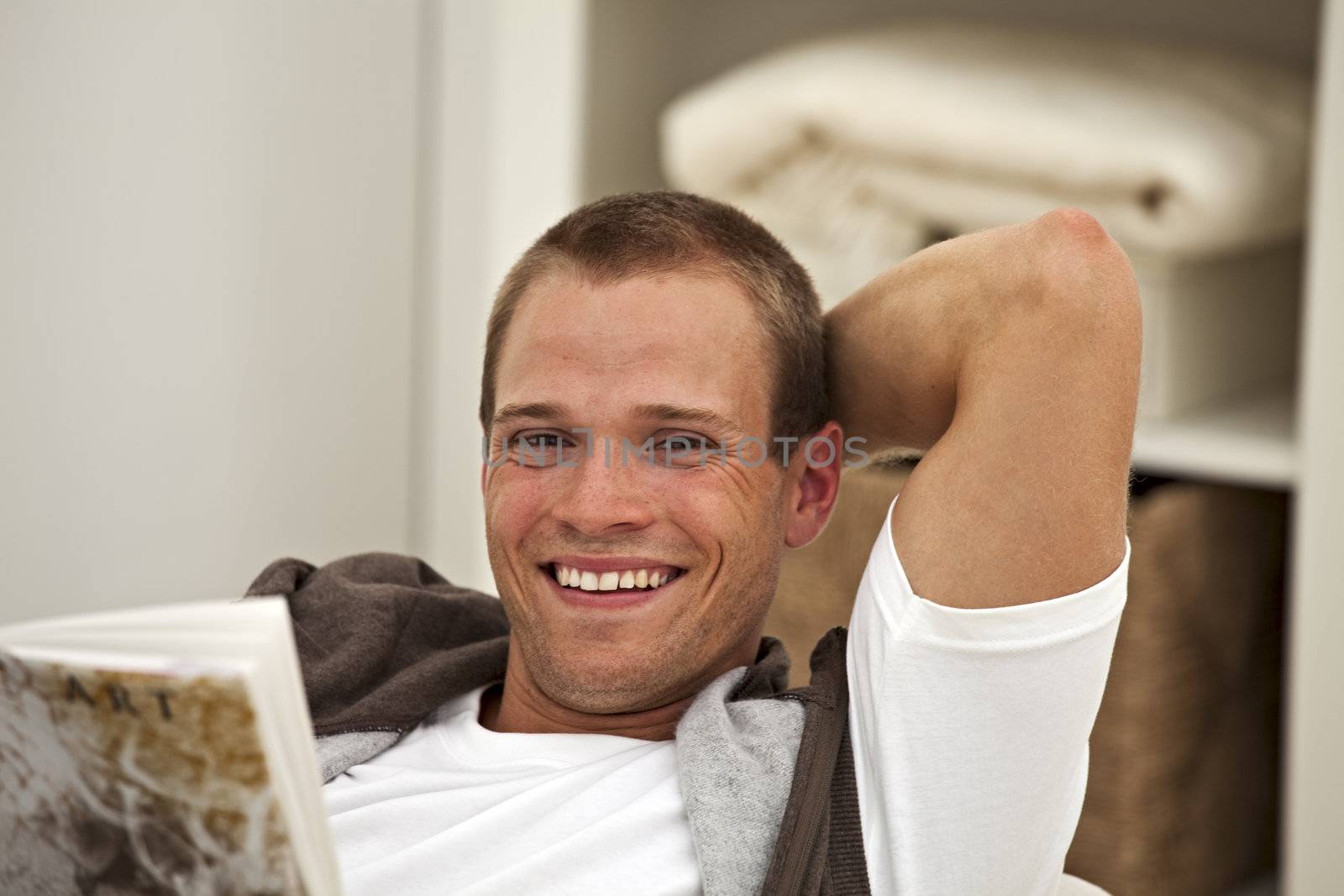 smiling young man reading a book