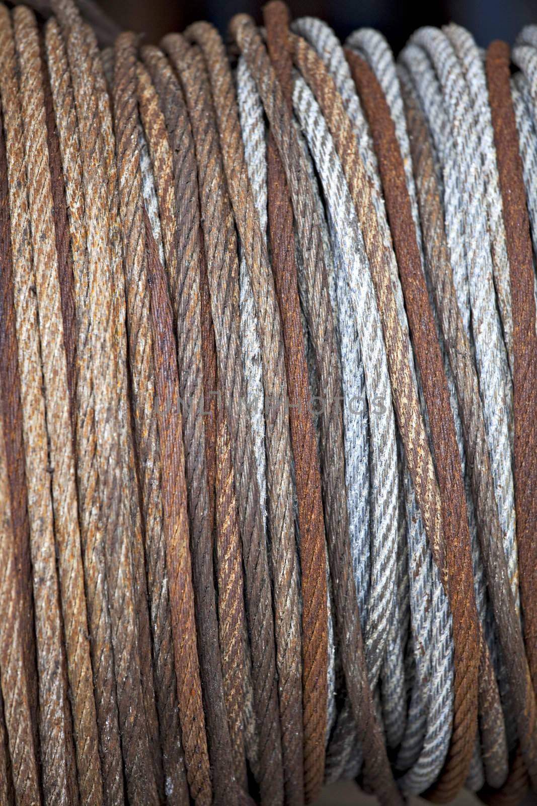 detail of a rusty roll of steel cable by bernjuer