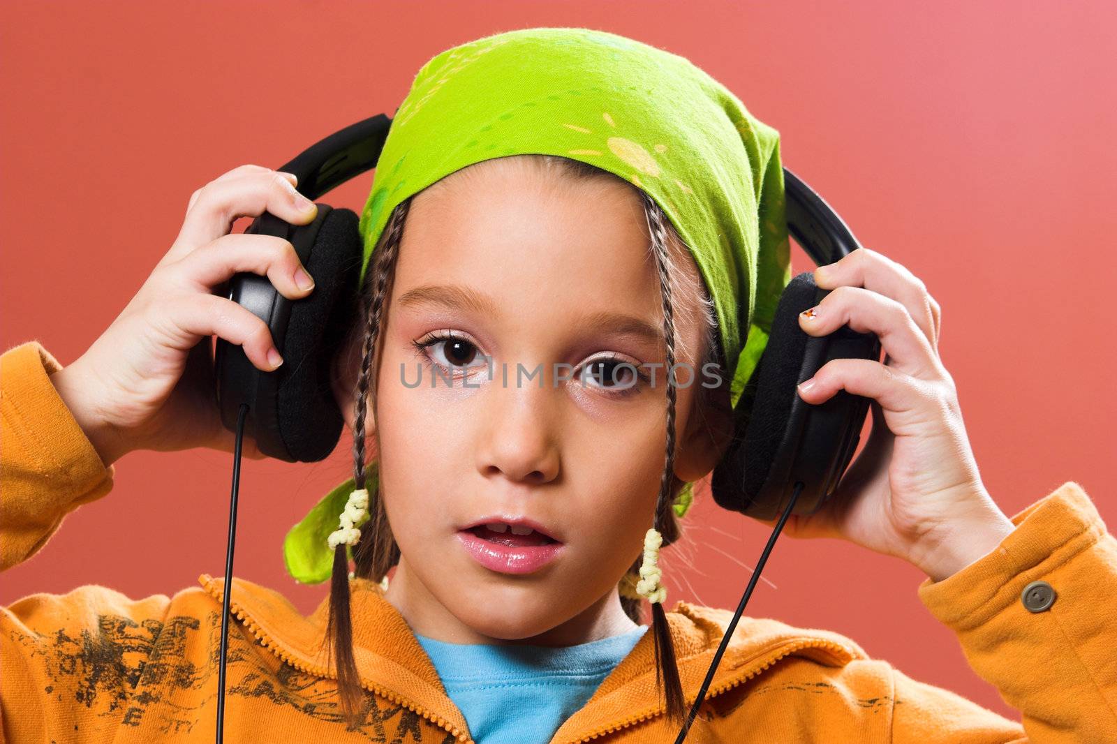 little pretty child listening music in headphones