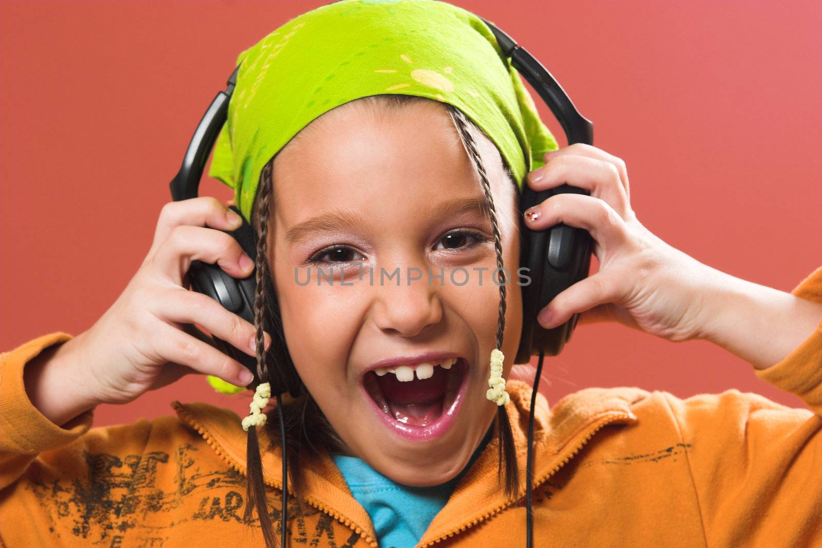 child listening music in headphones by vladacanon