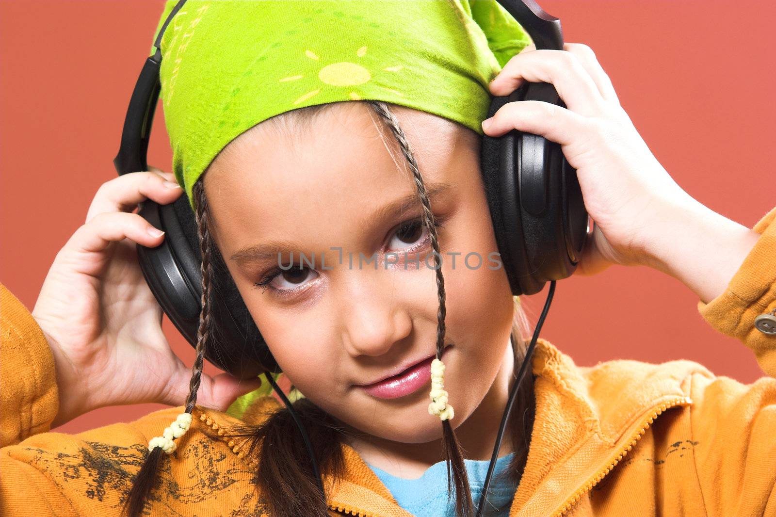 child listening music in headphones by vladacanon