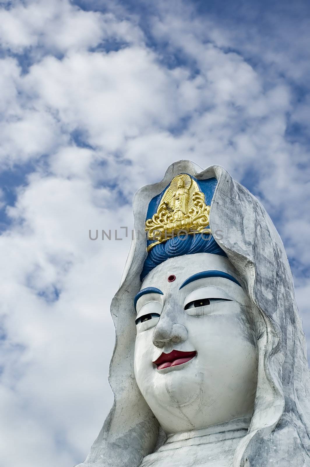 Guanyin statue with a white clouds background 