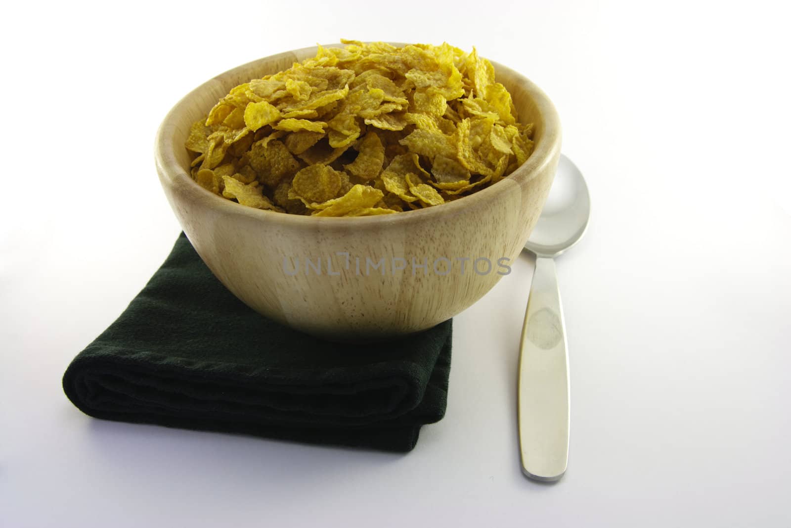 Cornflakes in a Wooden Bowl with Spoon by KeithWilson