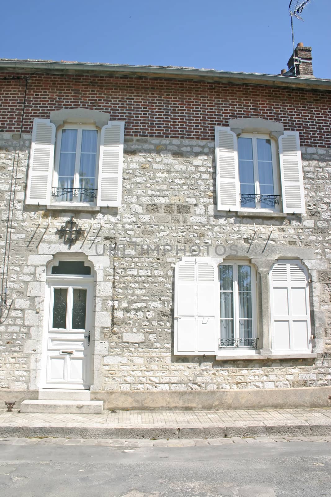 Old House with White Shutters in French Town
