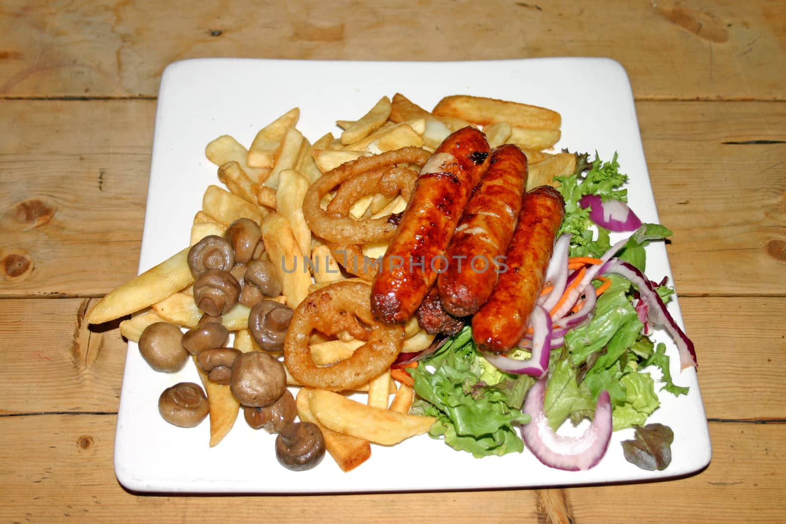 Plate of Sausages Chips and Onion Rings