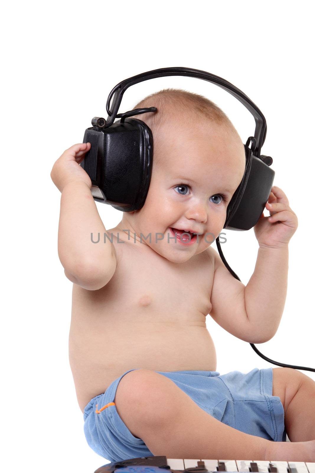 Little boy in headphones on the white background
