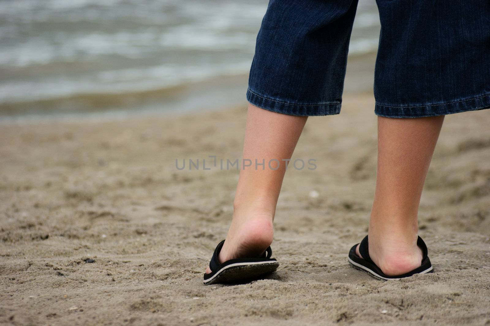 a boy standing at the beach 