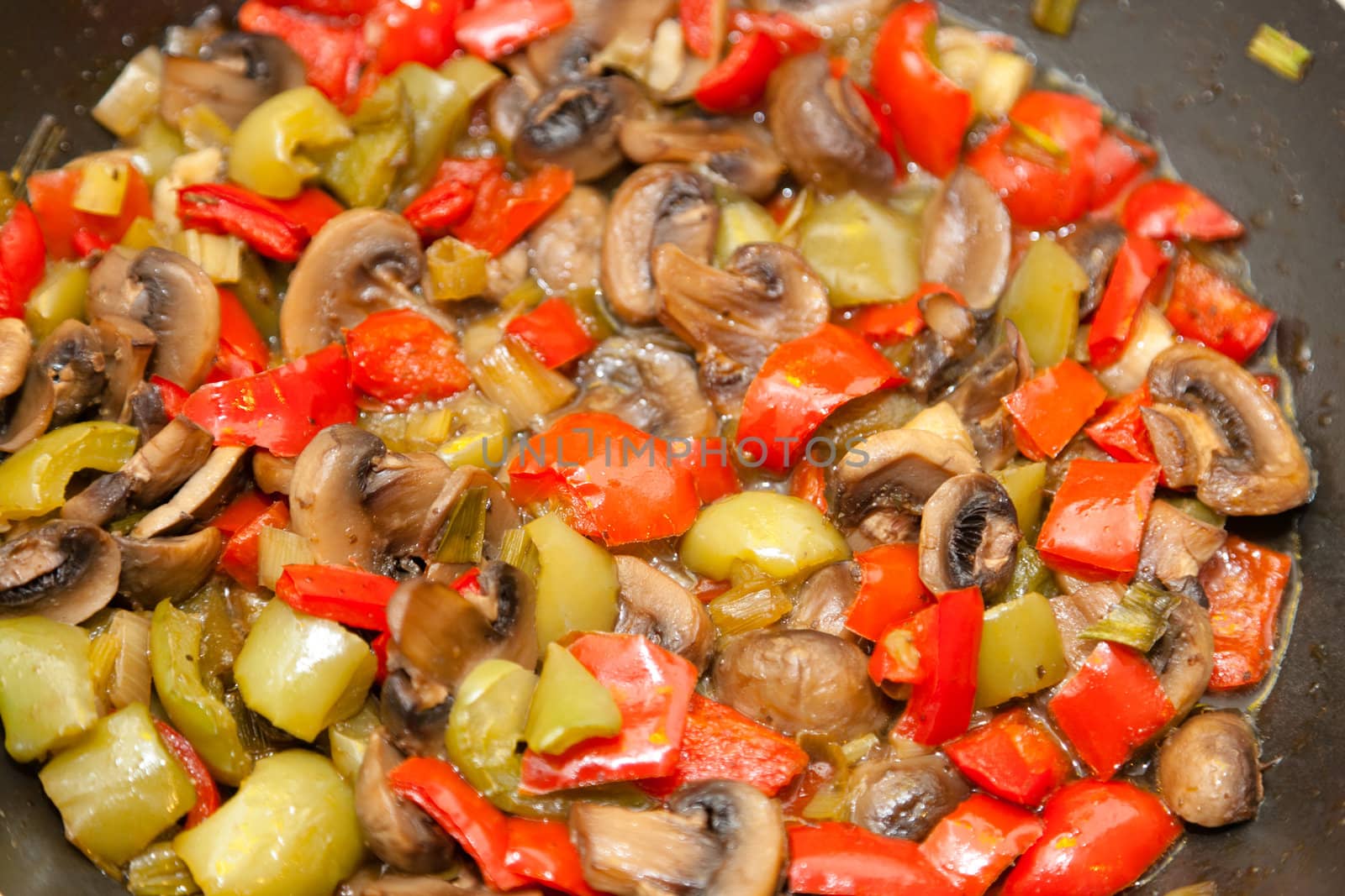Marinated Mushrooms with Red Bell Peppers in a frying pan.