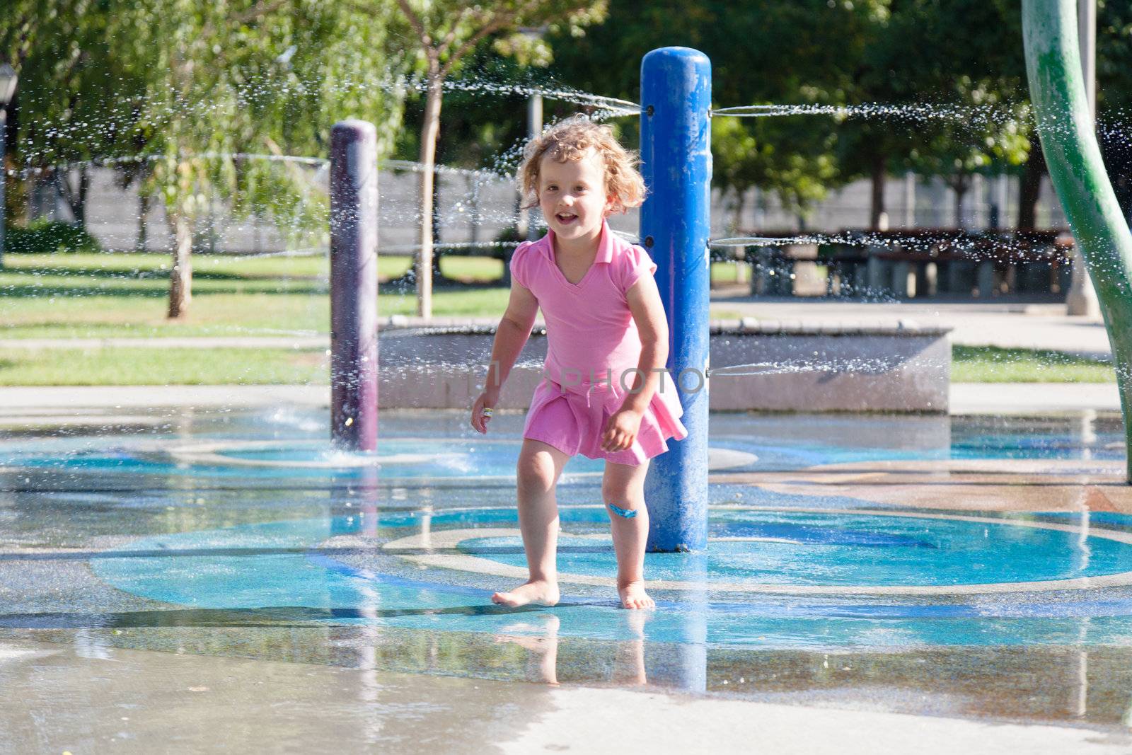 Having fun with water at the playground in park