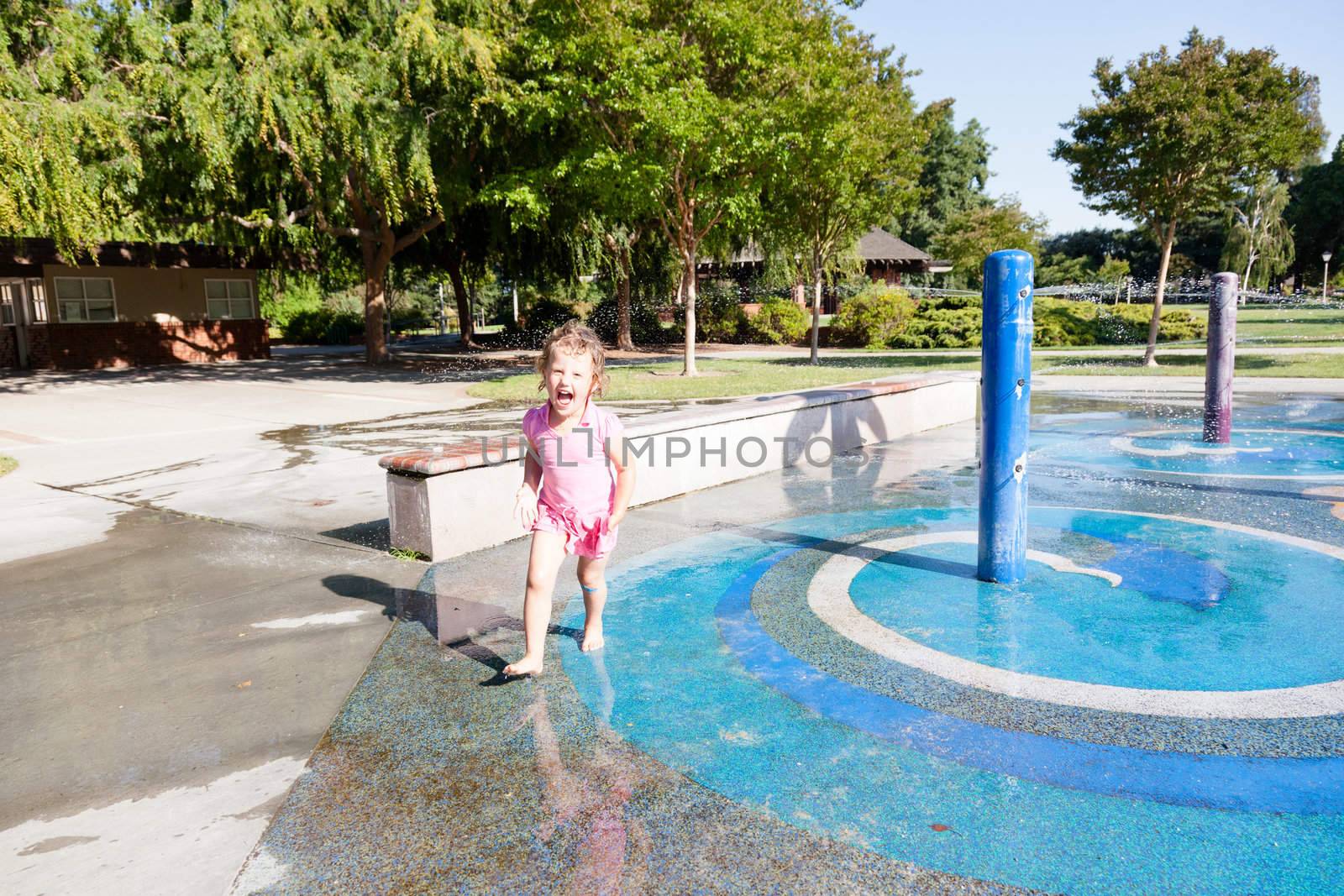 Having fun with water at the playground in park