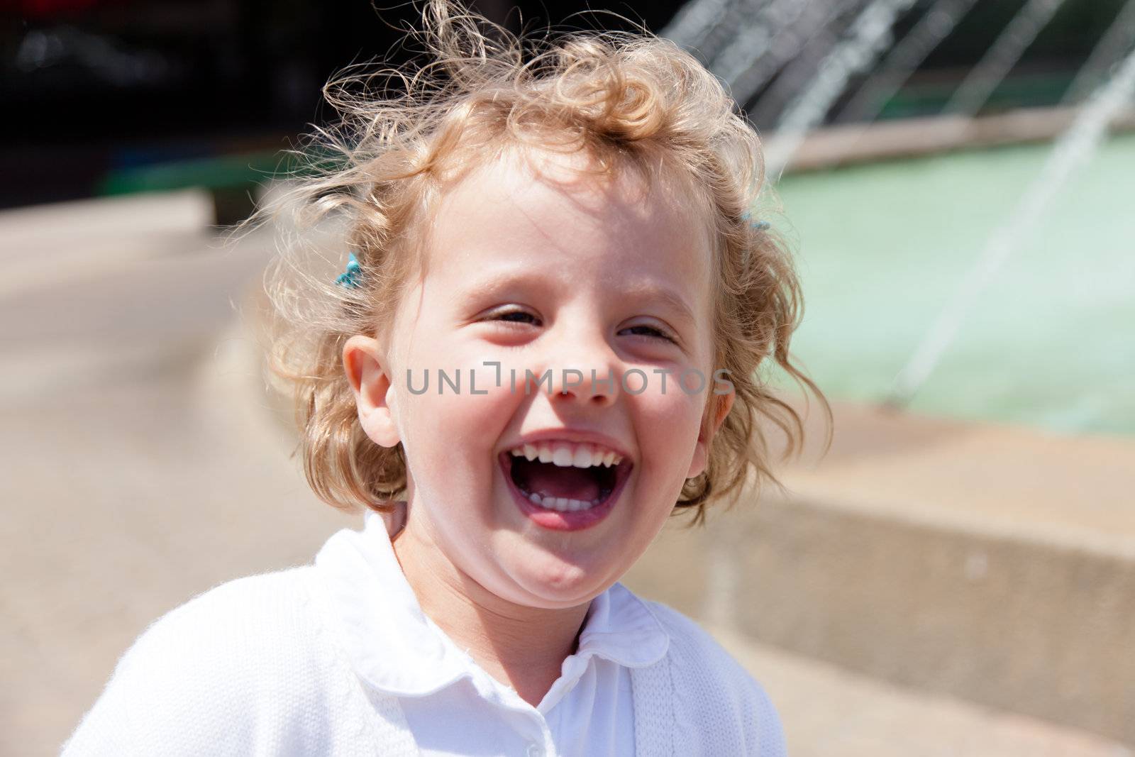 Having fun running around the fountain in the park.