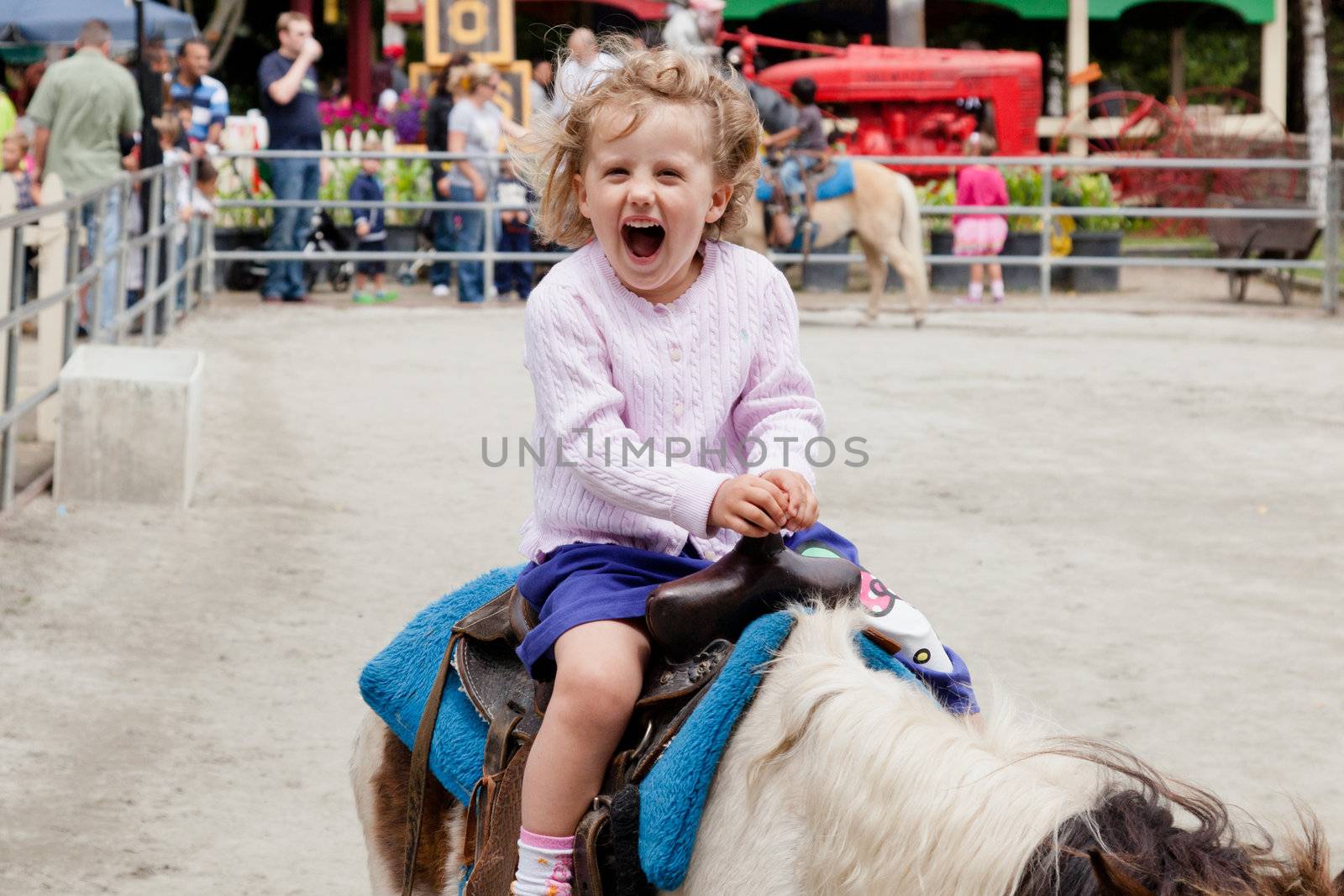 Having lots of fun riding a pony.