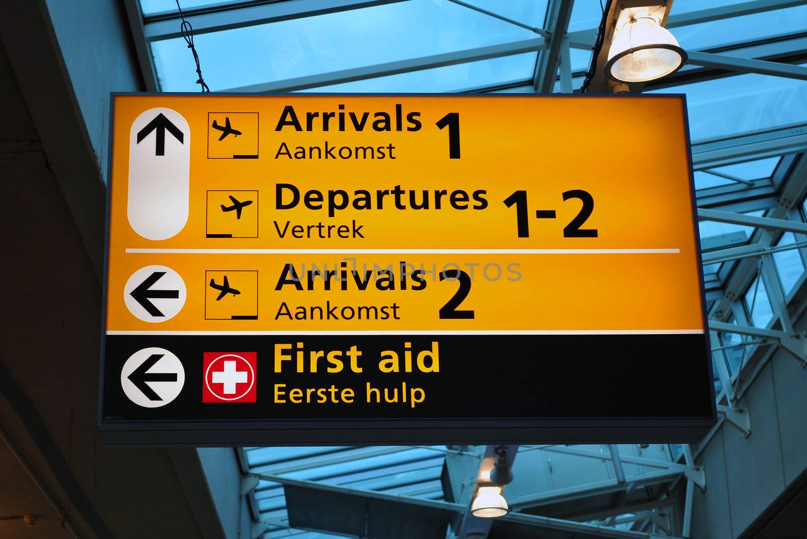 Airport sign: arrival, departures, first aid. Amsterdam Schiphol.