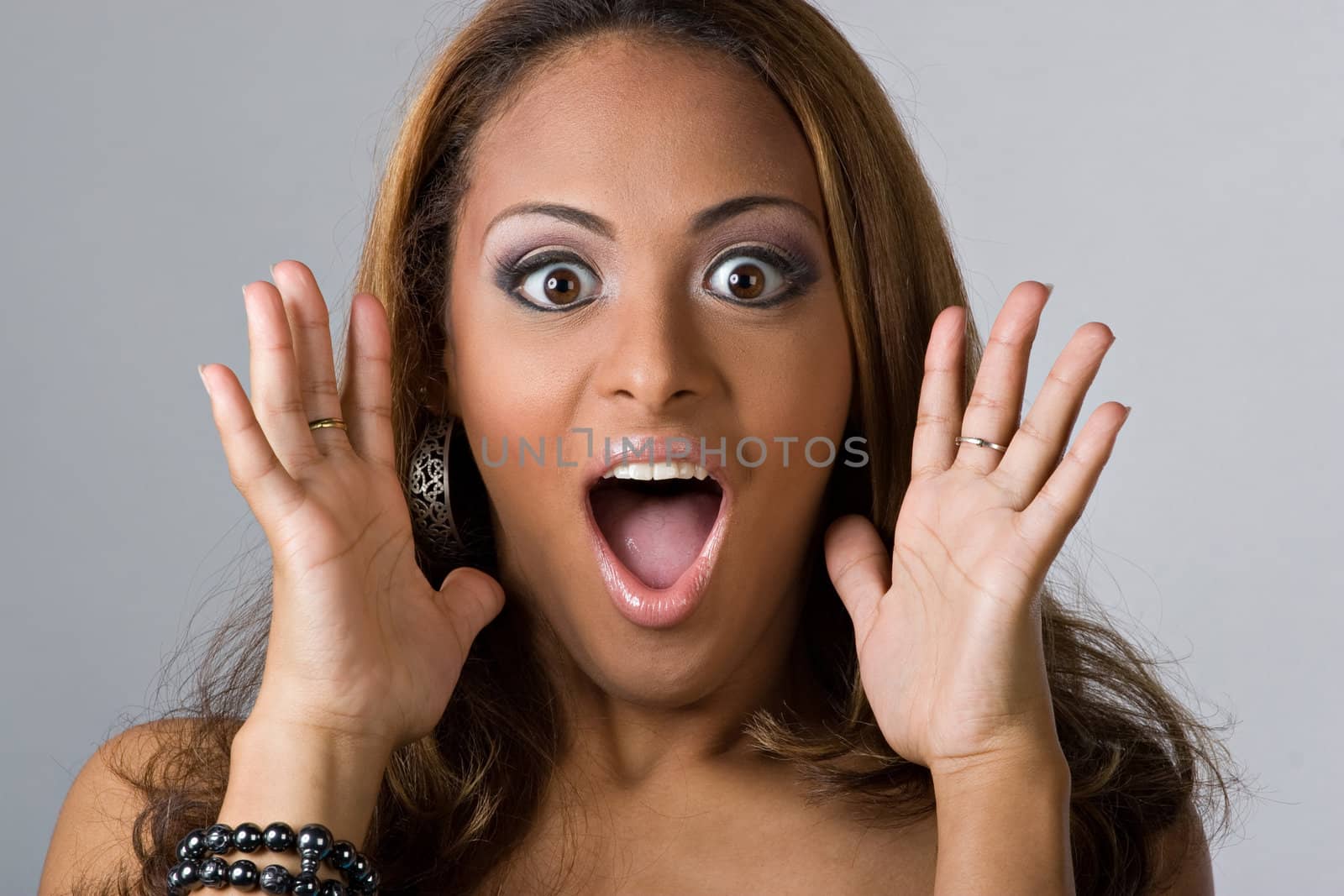 This young hispanic woman looks totally and completely surprised.