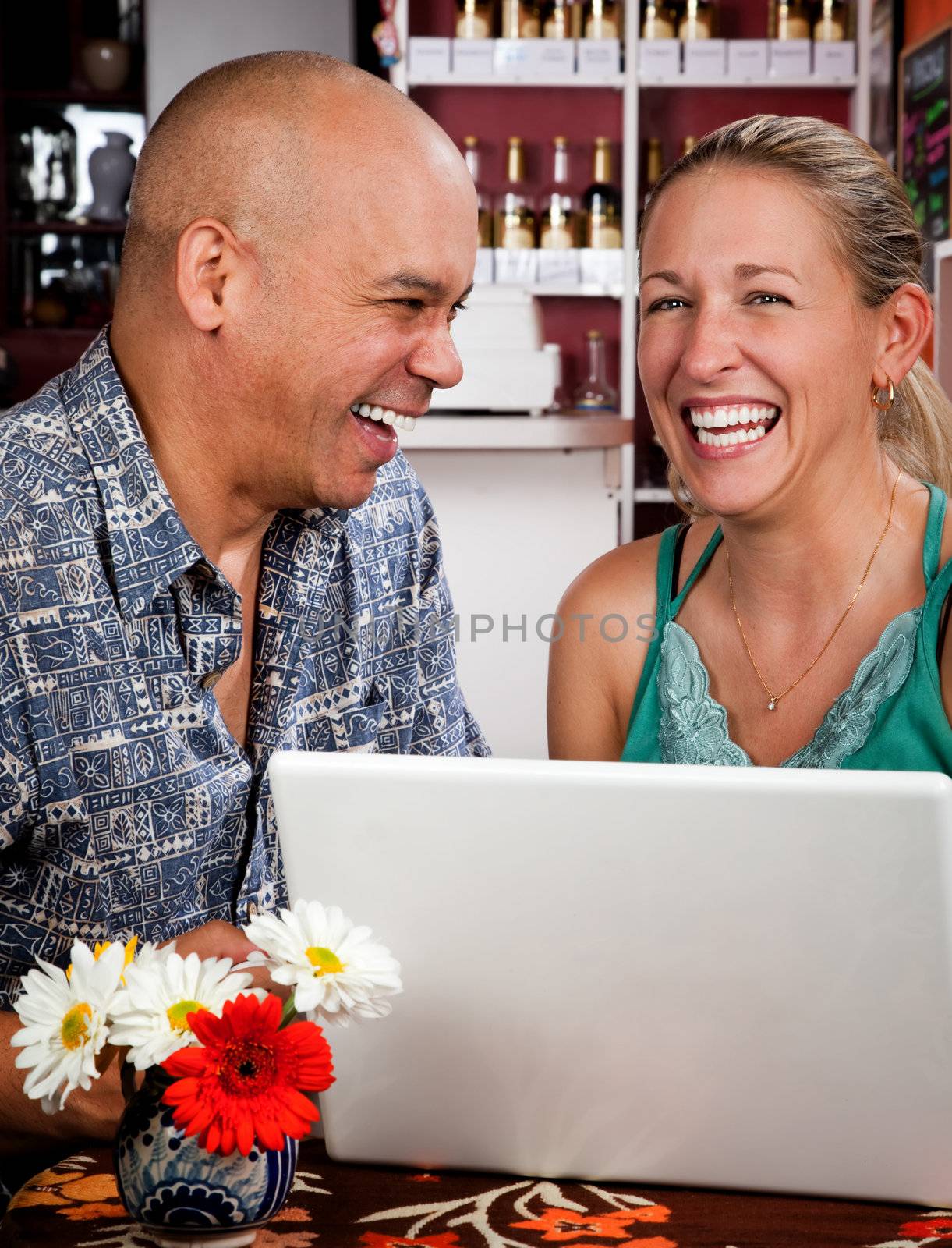 Attractive couple in a coffee house with laptop computer
