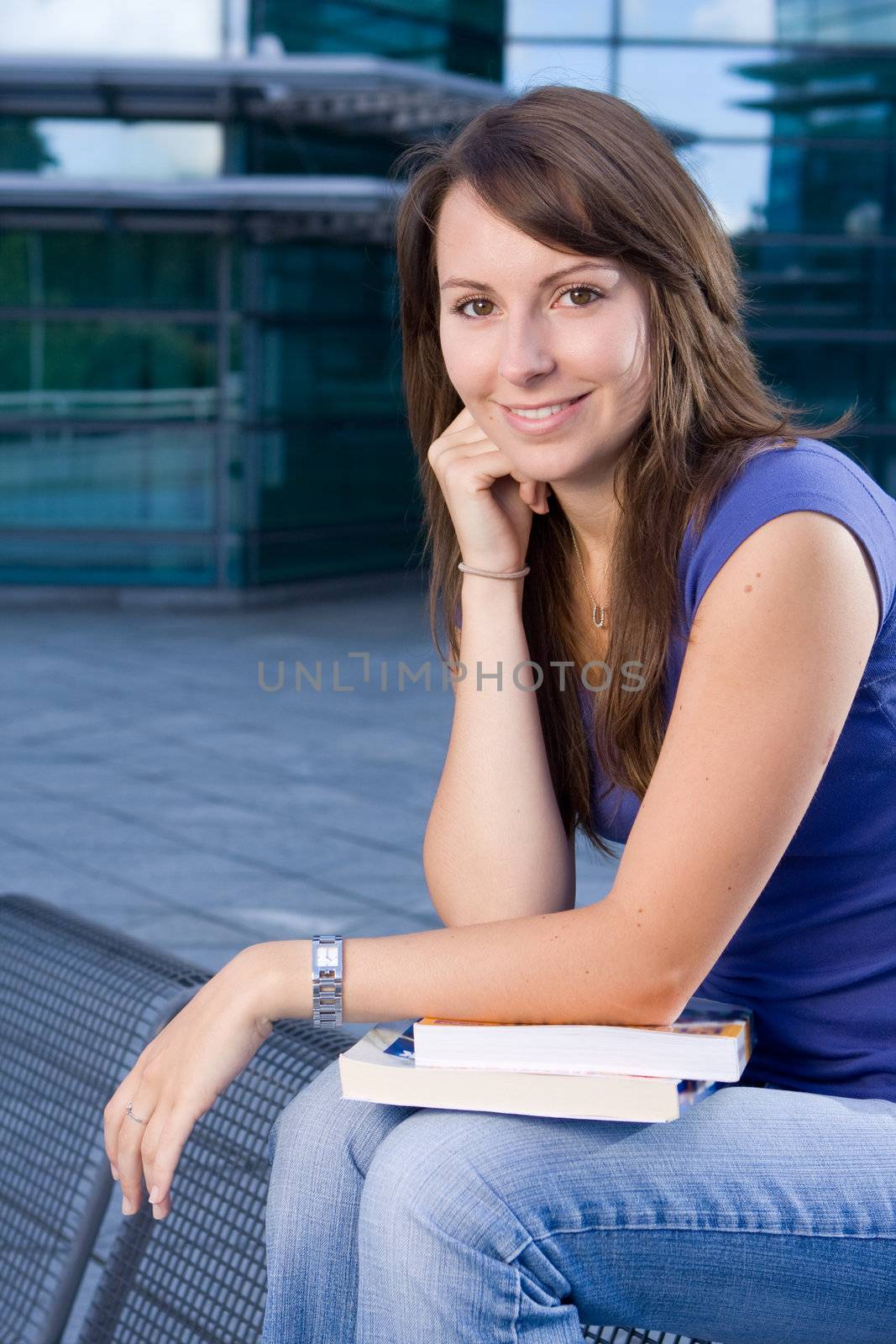 Pretty attractive caucasian girl sitting relaxing outside college school