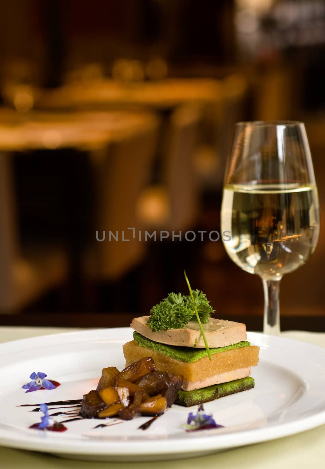 Gourmet dish and white wine, restaurant, copy space.