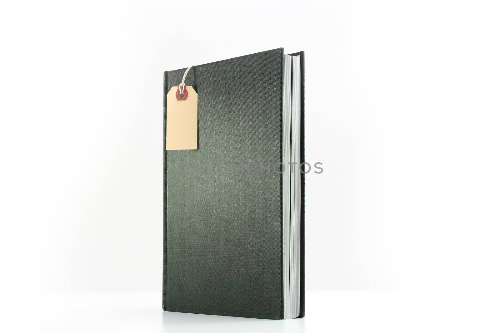 The book costs on a white background, in the book foreground the label hangs.