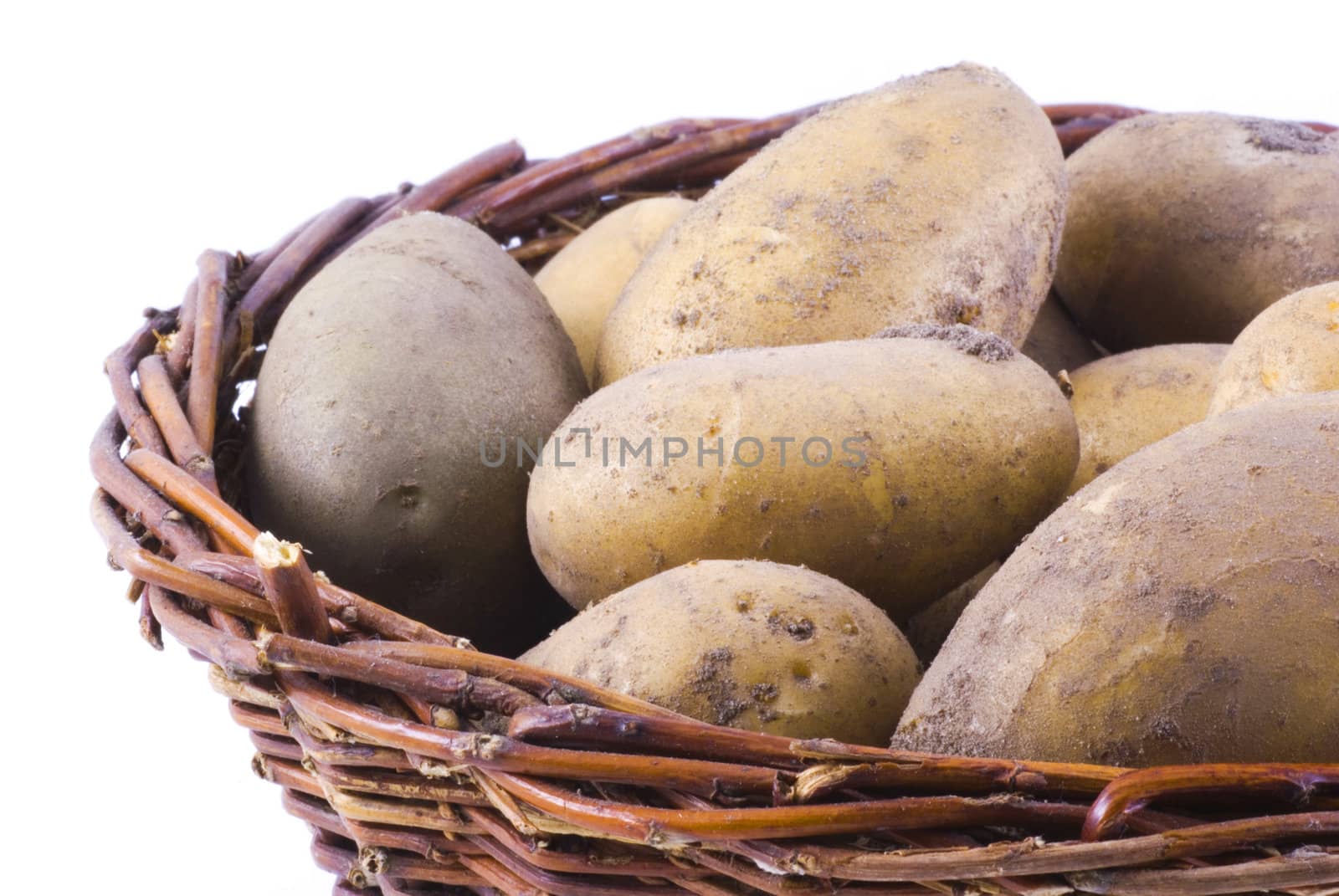 Macro photo of a basket full of potatoes, isolated on white.