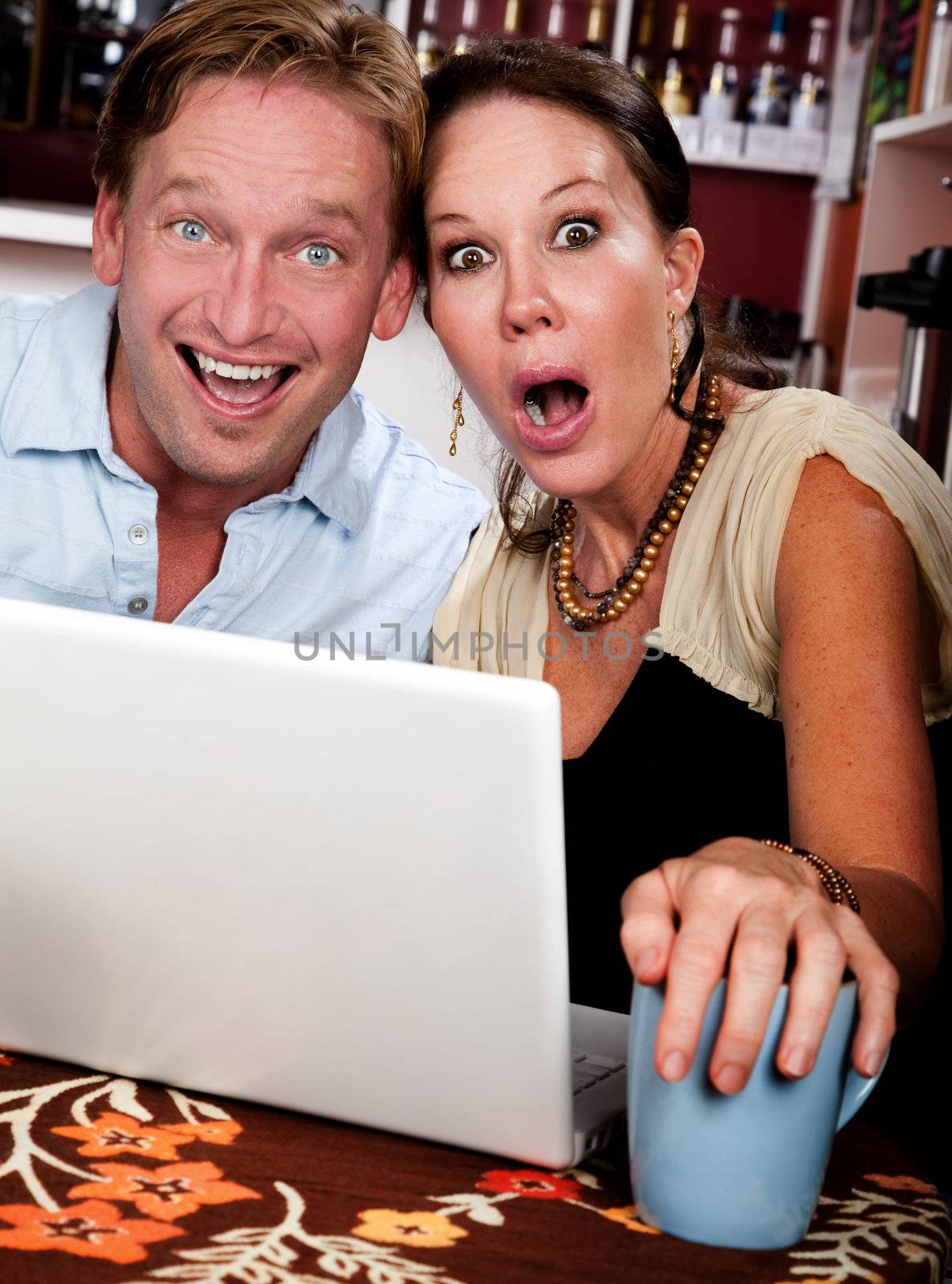 Couple in Coffee House with Laptop Computer by Creatista