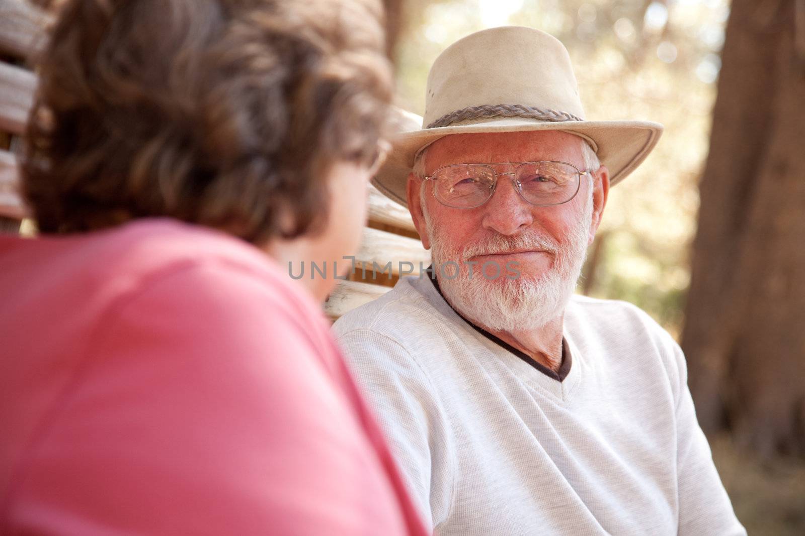 Loving Senior Couple Outdoors by Feverpitched