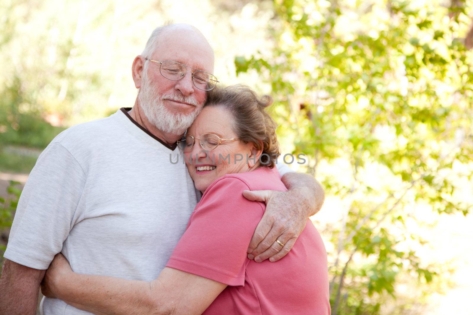 Loving Senior Couple Outdoors by Feverpitched