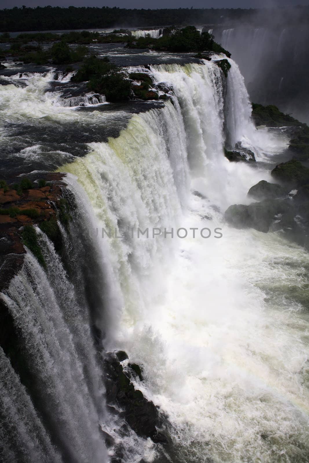 The Iguassu (or Iguazu) Falls is one of the largest masses of fresh water on the planet and divides, in South America, Brazil, Paraguay and Argentina. The waterfall system consists of 275 falls along 2.7 kilometres (1.67 miles) of the Iguazu River. Some of the individual falls are up to 82 metres (269 feet) in height, though the majority are about 64 metres (210 feet).