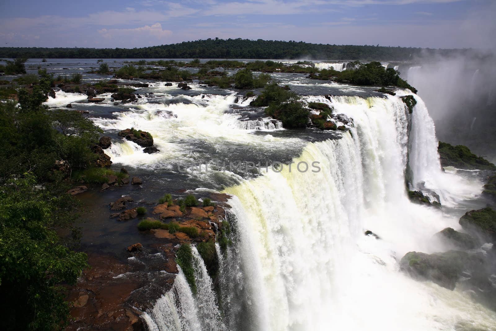 The Iguassu (or Iguazu) Falls is one of the largest masses of fresh water on the planet and divides, in South America, Brazil, Paraguay and Argentina. The waterfall system consists of 275 falls along 2.7 kilometres (1.67 miles) of the Iguazu River. Some of the individual falls are up to 82 metres (269 feet) in height, though the majority are about 64 metres (210 feet).