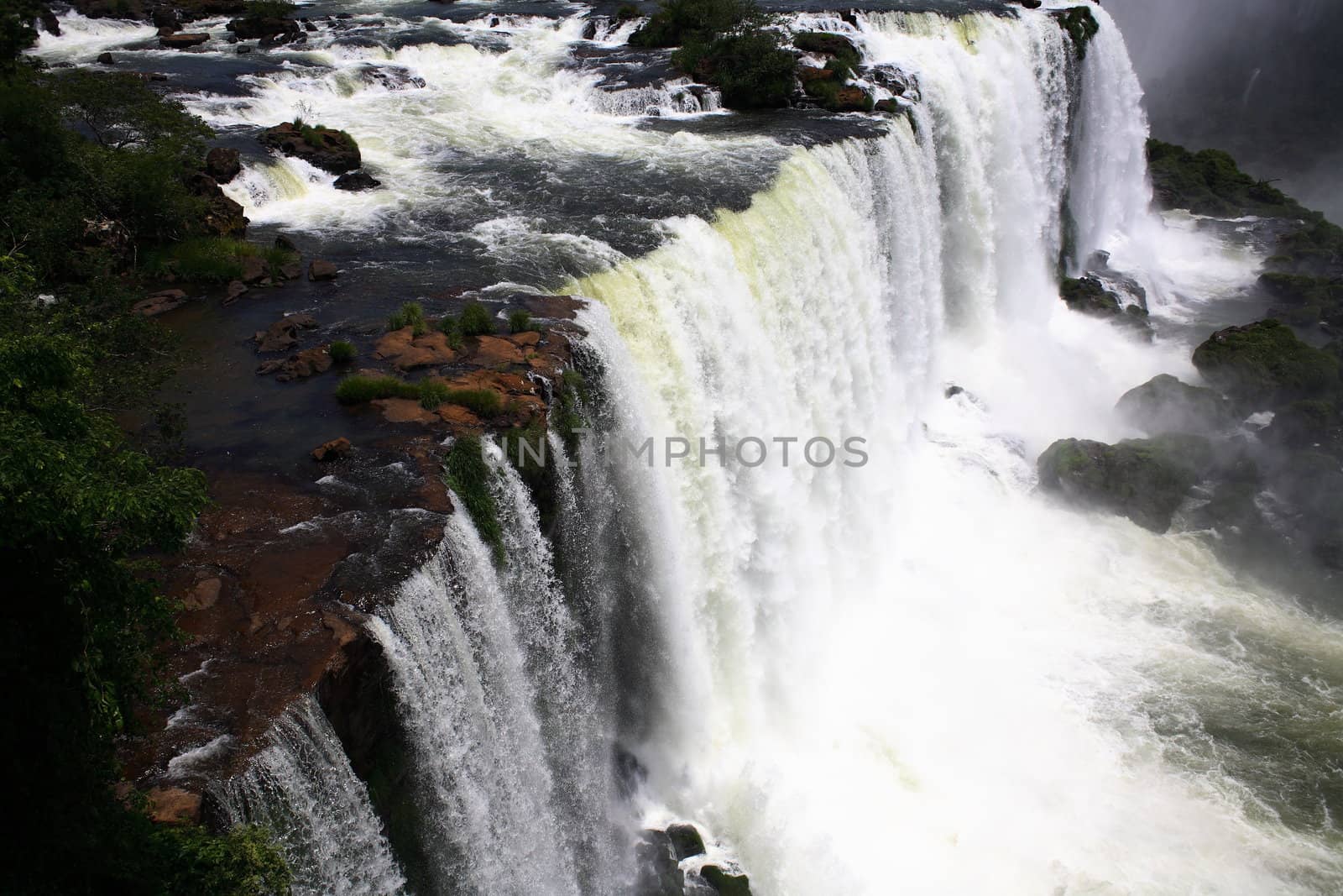 The Iguassu (or Iguazu) Falls is one of the largest masses of fresh water on the planet and divides, in South America, Brazil, Paraguay and Argentina. The waterfall system consists of 275 falls along 2.7 kilometres (1.67 miles) of the Iguazu River. Some of the individual falls are up to 82 metres (269 feet) in height, though the majority are about 64 metres (210 feet).