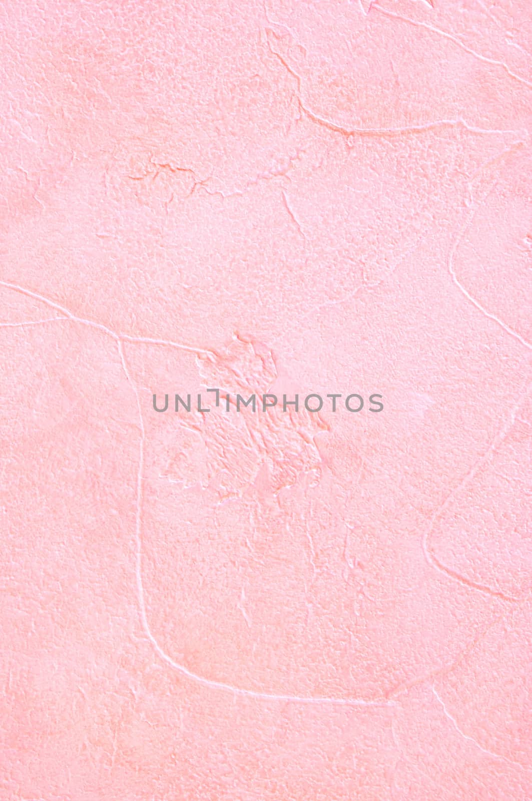 Light pink plaster with a deep relief on a wall