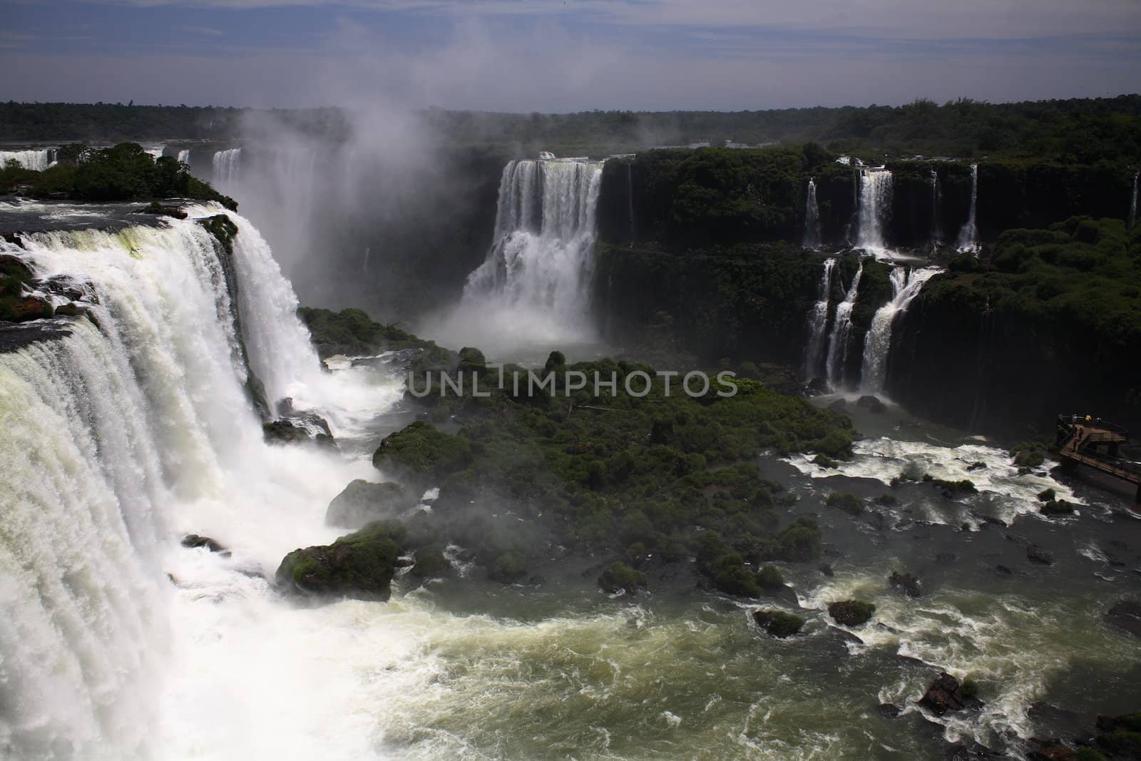 The Iguassu (or Iguazu) Falls is one of the largest masses of fresh water on the planet and divides, in South America, Brazil, Paraguay and Argentina. The waterfall system consists of 275 falls along 2.7 kilometres (1.67 miles) of the Iguazu River. Some of the individual falls are up to 82 metres (269 feet) in height, though the majority are about 64 metres (210 feet).