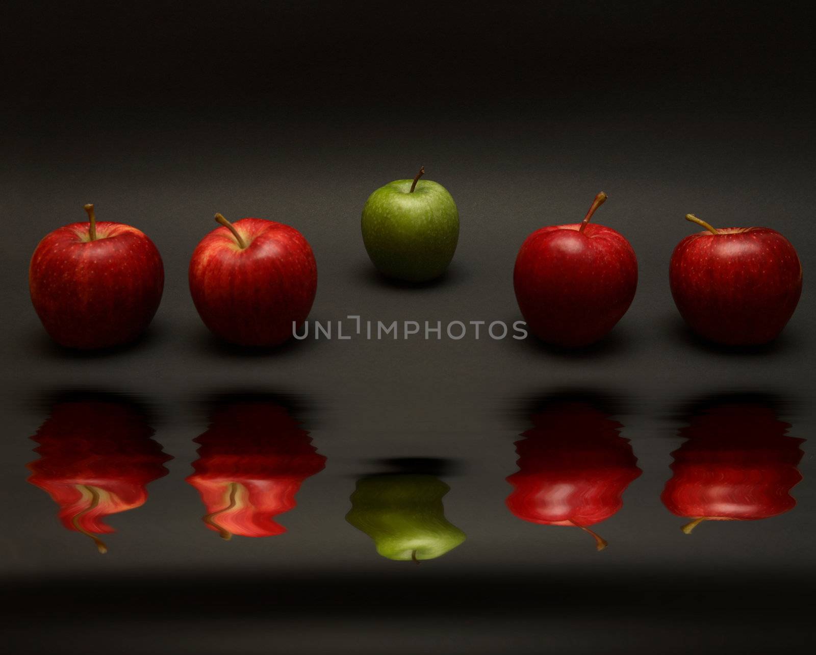 A line of apples, with one red one out.

(with water reflection)