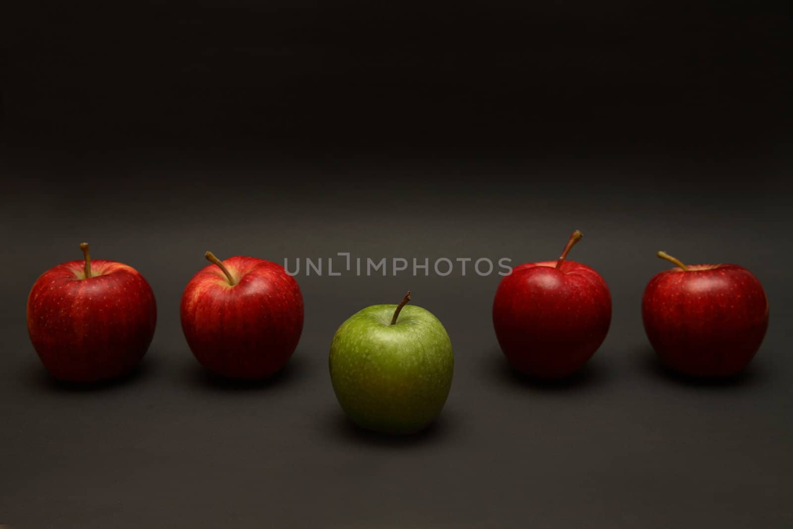 A line of apples with one exception.