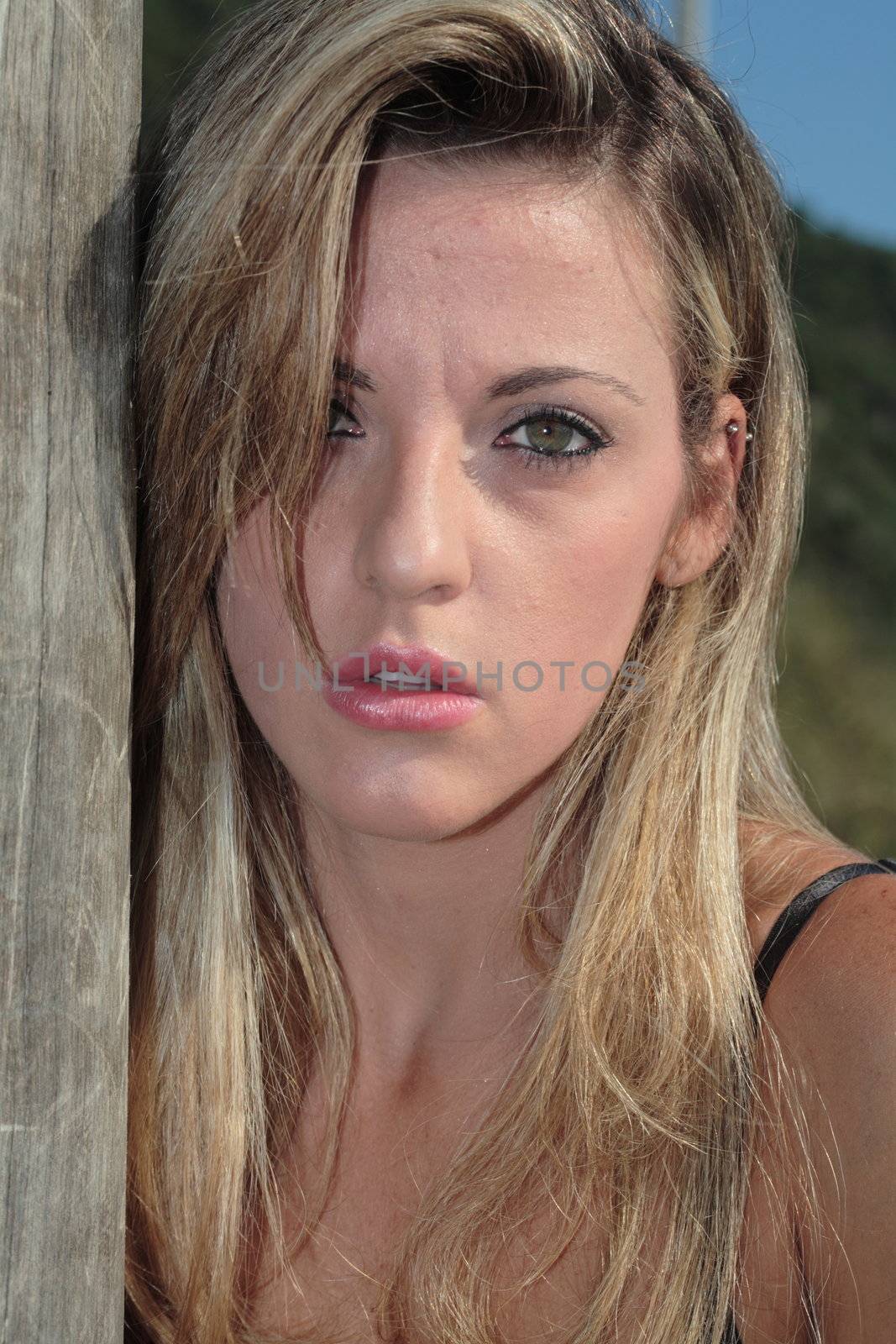 A blonde, 20-30 year old female model on the beach, in Florian�polis - Brazil. This is part of a series. Have a look at the other photos of this model in various outfits and poses.