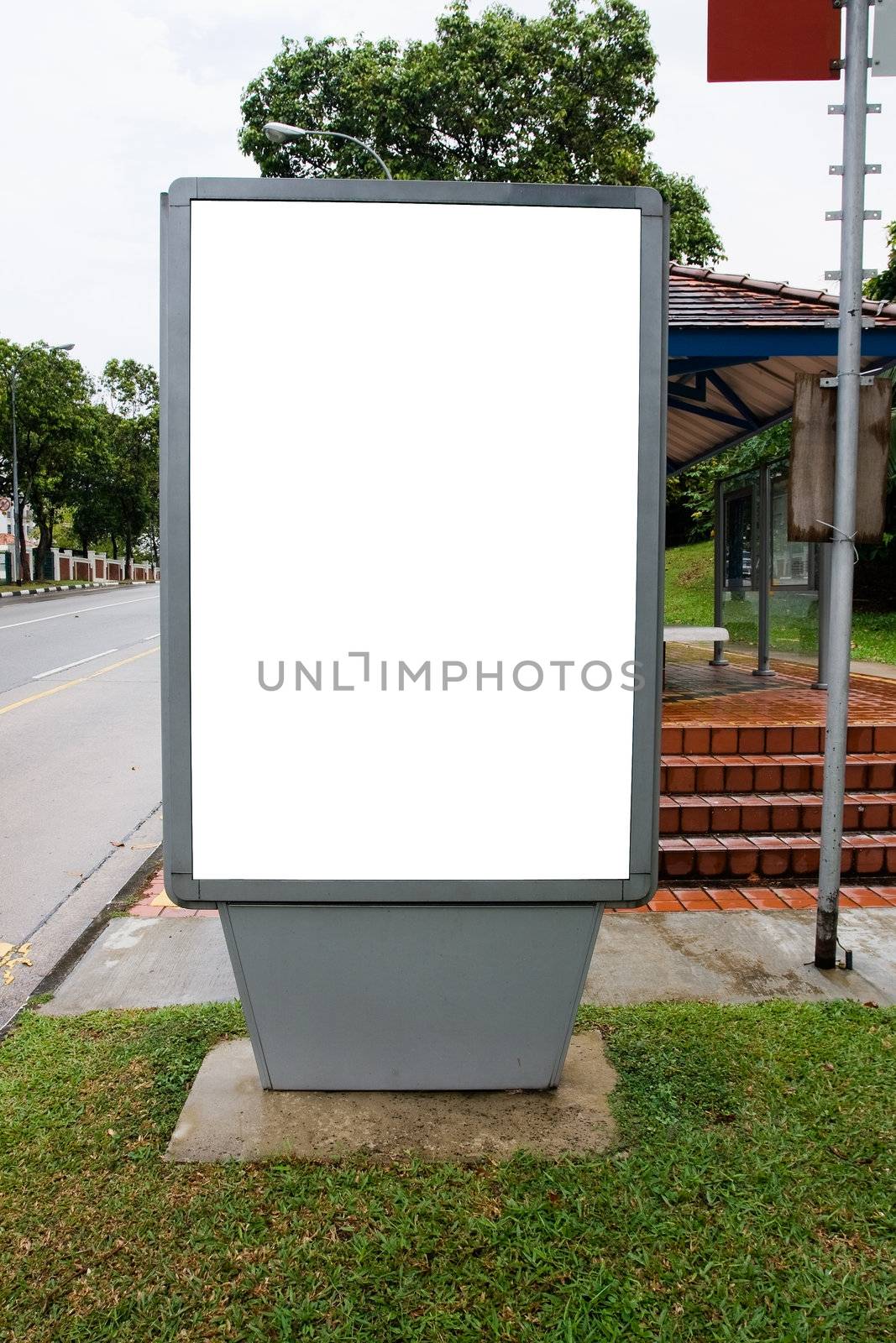 Blank billboard display at bus stop with clipping path for your advertising
