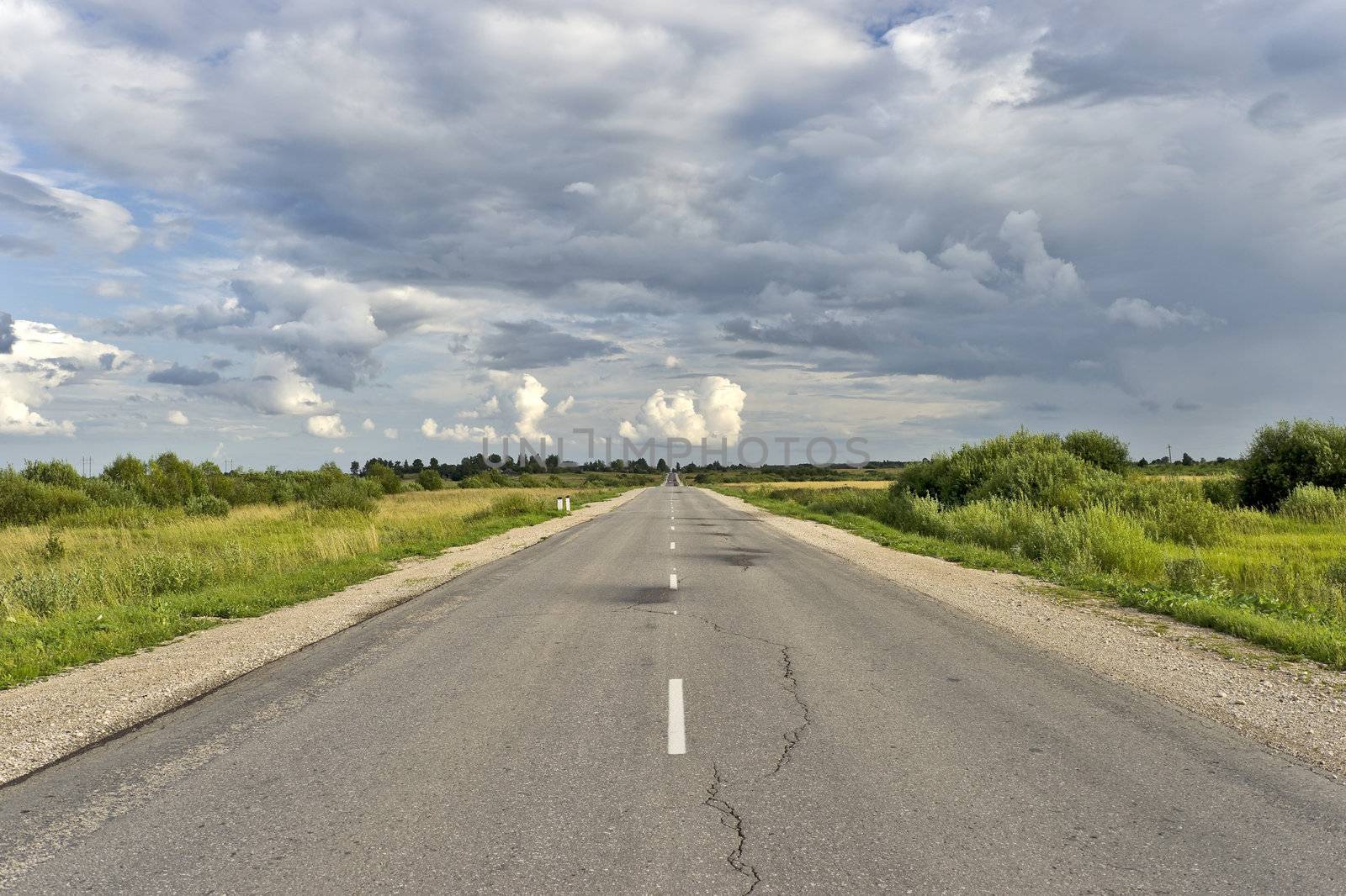 Countryside asphalt road with markings and cloudscape