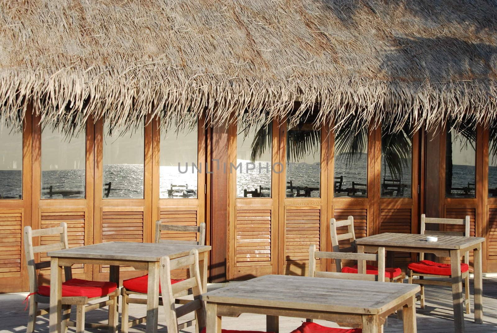 beautiful photo of a typical restaurant setting in a maldivian island (ocean reflection)