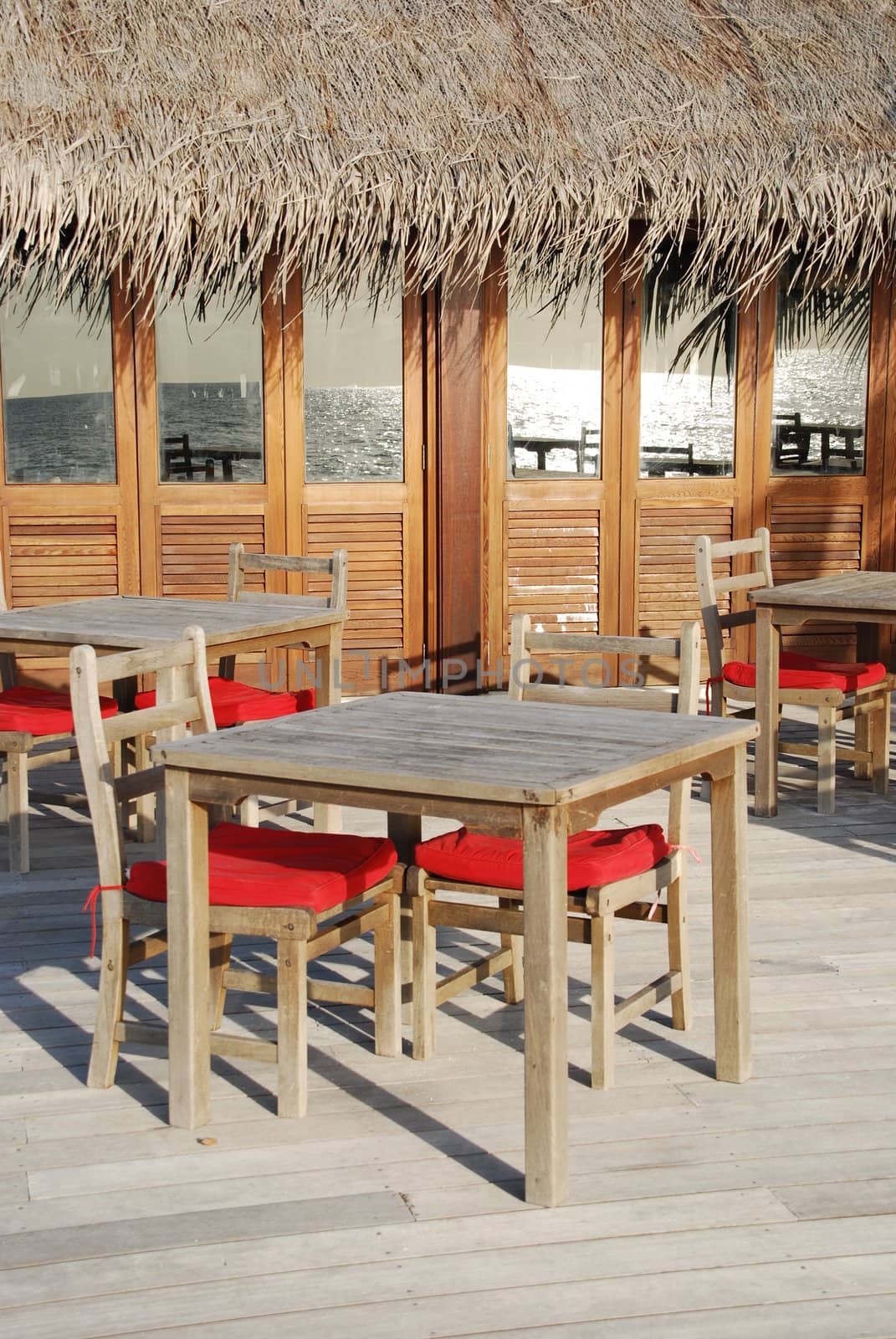 beautiful photo of a typical restaurant setting in a maldivian island (ocean reflection)