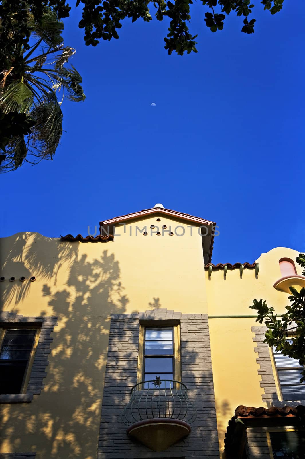 A half moon rises over an art-deco building in Miami, Florida.