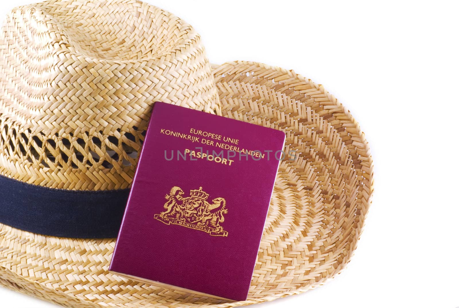 Straw hat with passport, isolated on a white background.