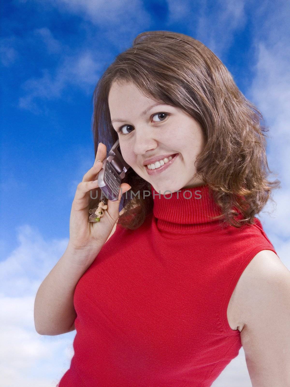 beautiful girl talking by mobile phone in the sky