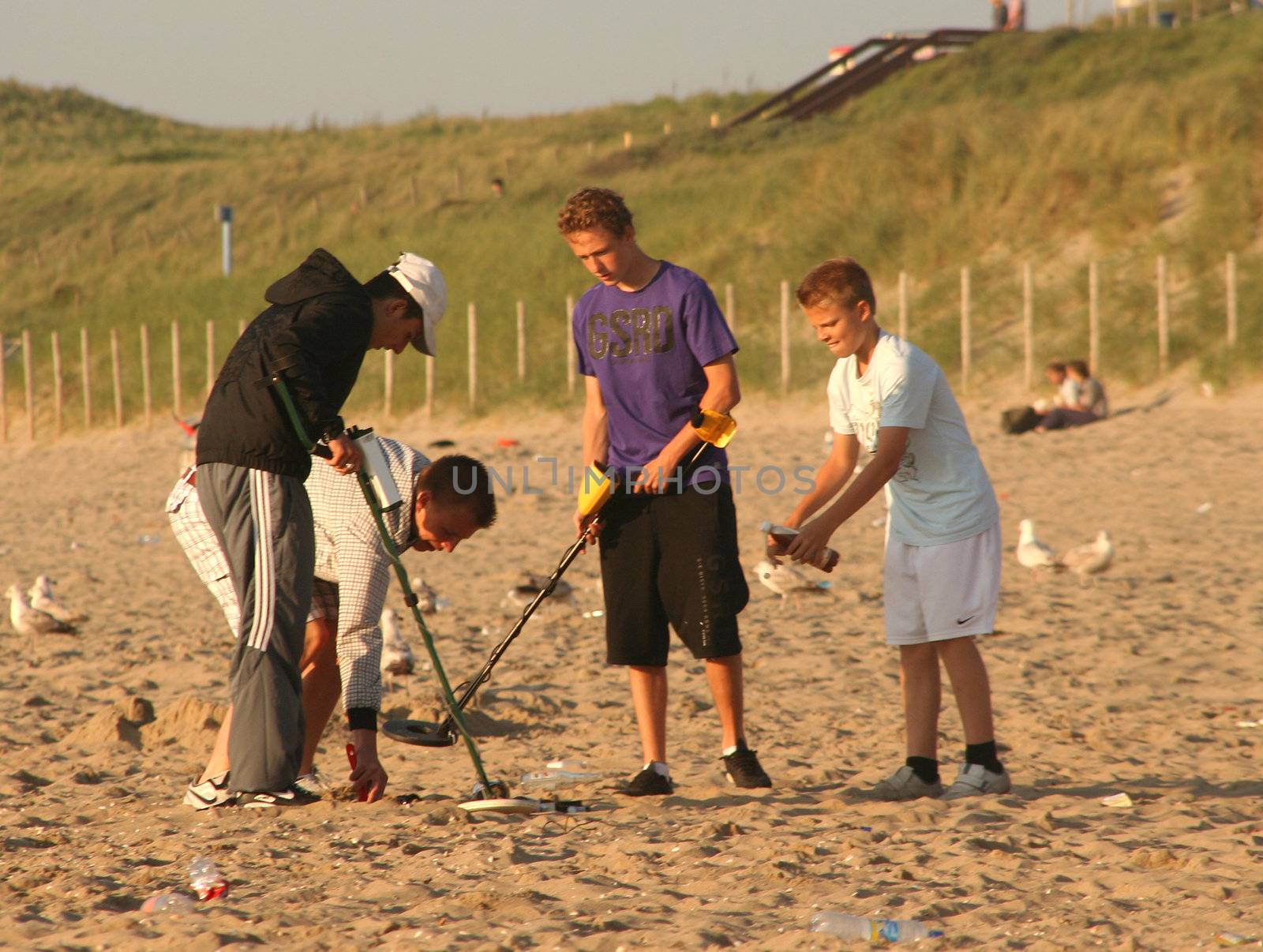 Boys with metal detectors at the beach