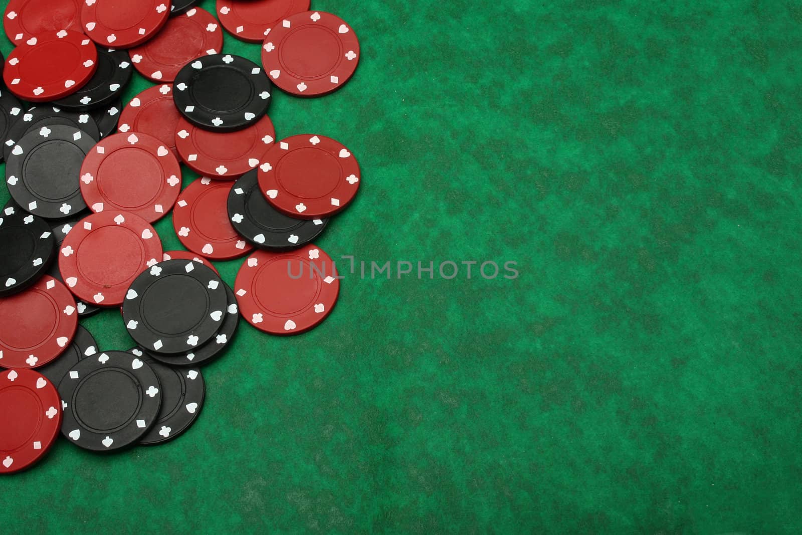 Gambling chips over green felt with copy space by Erdosain