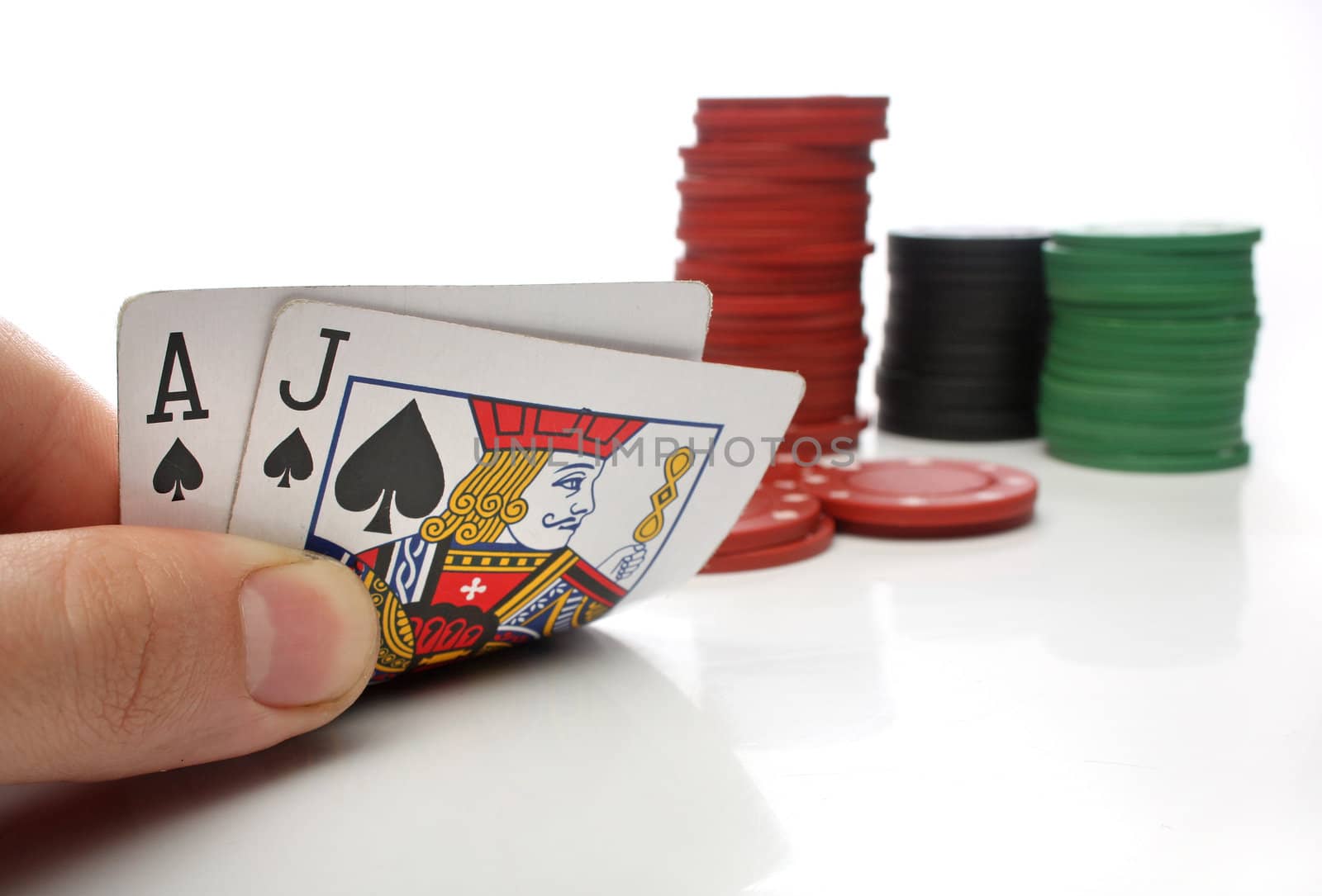 Blackjack. Human hand with blackjack cards and gambling over white