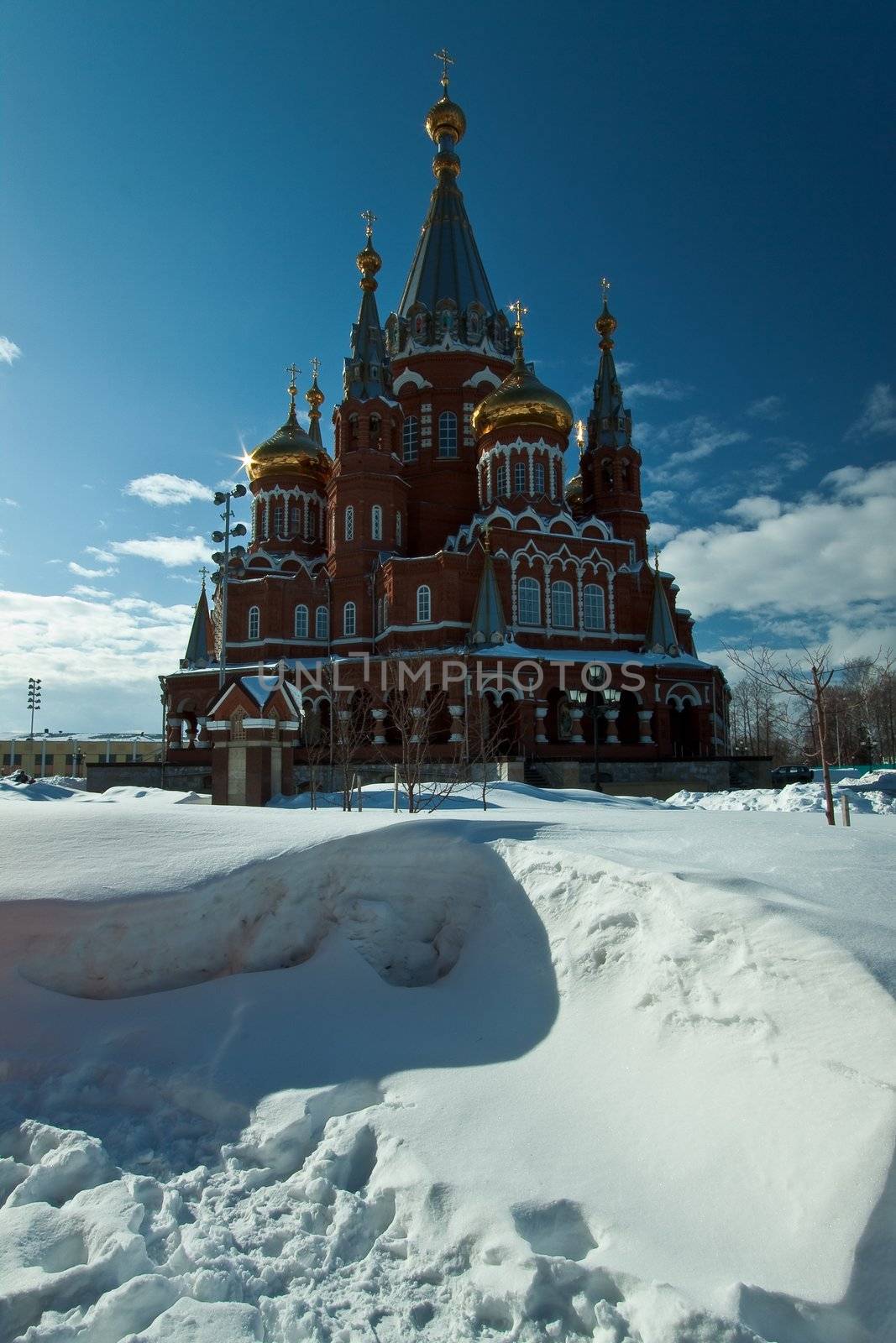 Picture is very beautiful building, on a background of sky and clouds