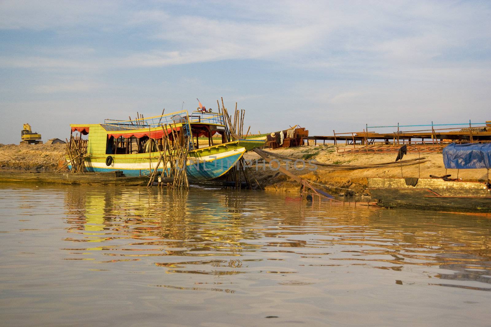 Image of a boat under repair at Chong Kneas river, located at the edge of the Tonle Sap Lake of Cambodia.