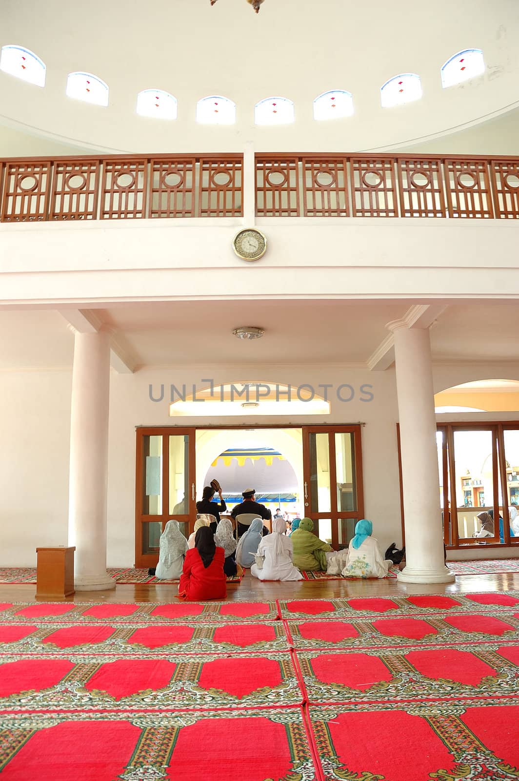 masjid hall with red carpet and white marble wall